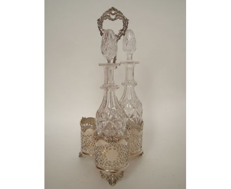An early Victorian Old Sheffield Plate three bottle decanter stand, the trefoil shaped stand with scrolling pierced work side