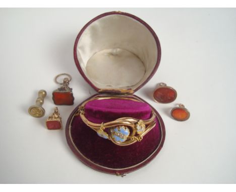 A Victorian diamond and blue enamel decorated gilt metal crossover hinged bangle (some loss to enamel) in fitted case, togeth