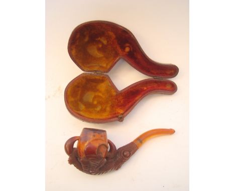 A late 19th Century meerschaum pipe, carved, a claw holding an egg, in fitted case, 13cm long. 