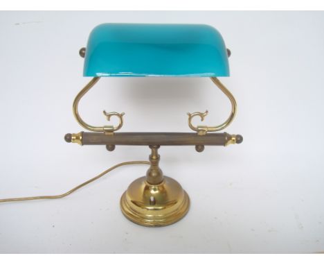 A gilt brass desk lamp with green glass shade. 