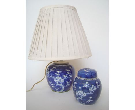 A Chinese blue and white ginger jar fitted as a table lamp and another similar ginger jar and cover. 