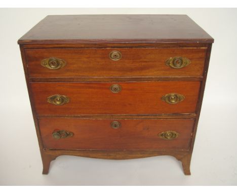 A George III mahogany chest of drawers, the crossbanded top with reeded edge over three graduated long drawers with oval bras