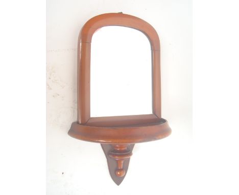 A Victorian walnut wall bracket with mirror back. 