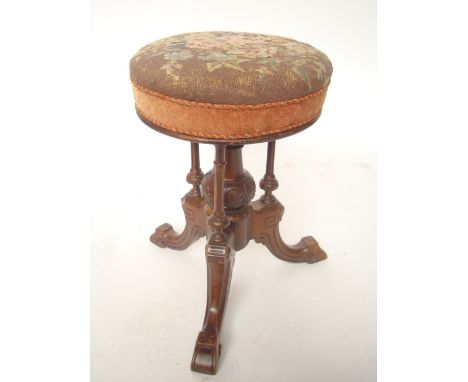 A Victorian piano stool, the tapestry upholstered adjustable seat on central stem and three supports, raised on three outswep