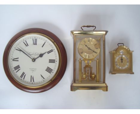 A German gilt brass anniversary clock with quartz movement, a battery operated wall clock and a Swiza gilt brass bracket cloc