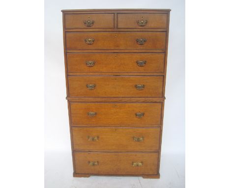 A George III oak chest on chest, the upper section with two short and three graduated long drawers, over three further gradua