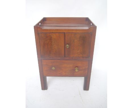 A George III mahogany tray top commode, the top with raised gallery and carrying handles above a pair of cupboard doors and a