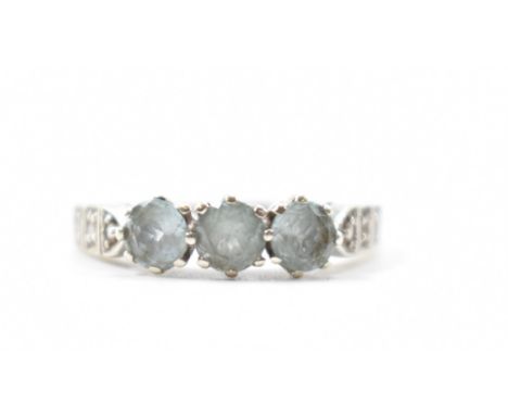 A hallmarked 9ct gold aquamarine &amp; diamond three stone ring. Hallmarked for Sheffield. Weight approx 2.9g. Size M.
