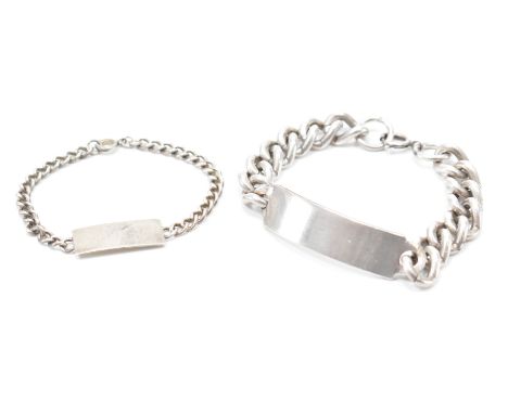 A pair of hallmarked silver identity bracelets. Both having curb link chains, identification panels &amp; spring ring clasps.