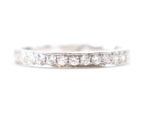 A hallmarked 18ct white gold and diamond half eternity ring. The ring being set with sixteen round brilliant cut diamonds. We