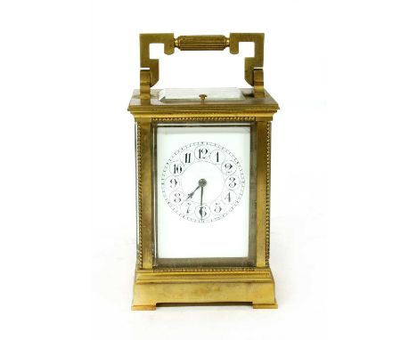A French brass carriage clock, with repeating mechanism and silvered platform, striking the half hours on a gong. 18cm high (