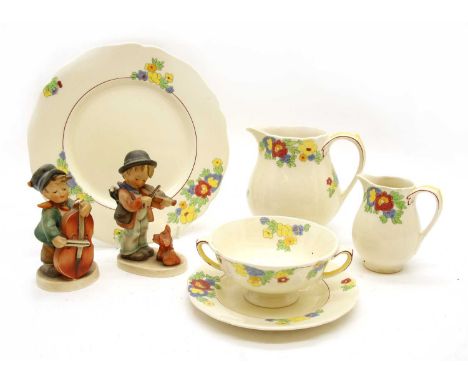 A Royal Doulton Minden pattern D5334, having stylised foliate decoration on a cream ground, together with two Hummel figures