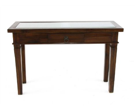 An Asian hardwood console table, the rectangular top with an inset carved panel under glass, over a single frieze drawer on s