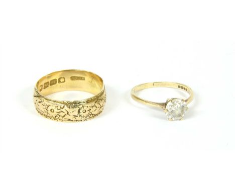 An 18ct gold wedding band, decorated with a floral frieze, misshapen, 5.3g, together with a white stone set 9ct gold ring, 1.