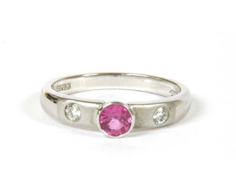 An 18ct white gold single stone pink sapphire ring, with diamond set shoulders with a circular mixed cut pink sapphire, with 