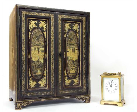 A 19th century Japanese black lacquer table cabinet, with gilt detailing, fitted pair of panel doors enclosing drawers, 28cm 