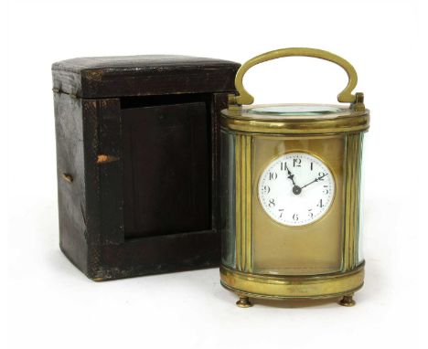 An oval French brass carriage clock, in a leather travelling case,
