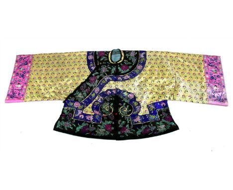 A Chinese embroidered winter jacket, the ruyi- shaped border embroidered with chrysanthemum, pomegranate, finger citrons and 