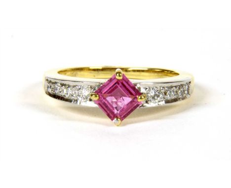 An 18ct two colour gold pink sapphire and diamond ring, with a square cut pink sapphire with a stated weight of 0.93ct, four 