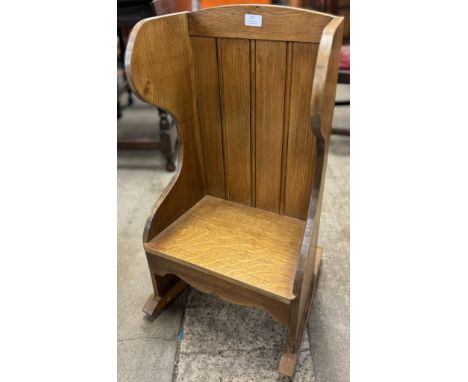 A childs oak rocking pew 