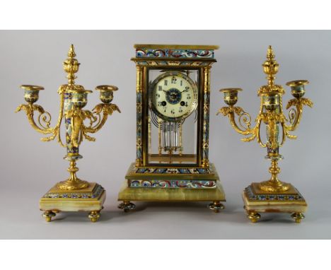 A French champleve enamel and green onyx clock garniture, late 19th century/early 20th century, the clock with rectangular gl