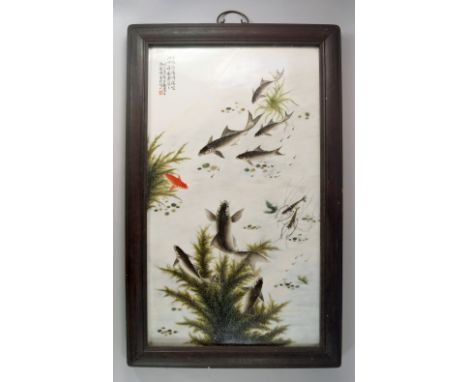 Follower of Deng Bishan(1874-1930), A porcelain plaque of fish and weeds, bears seal marks and calligraphy to the top left, e