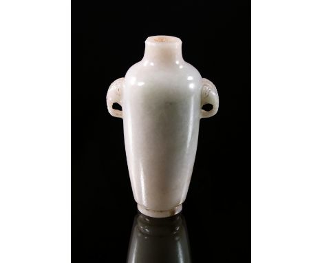 A Chinese pale jade snuff bottle, 19th century, elephant handles, raised on flared foot, 7 cm high. 