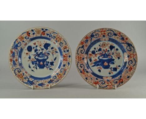 Two Chinese porcelain plates, 18th century, painted in the Imari palate with central reserves of lotus in jardiniere's, with 