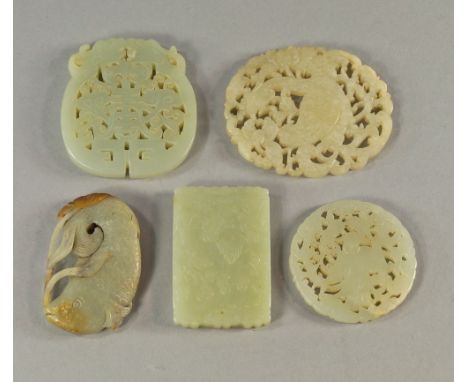 A Chinese jade pendant, 20th century, pierced as a model of a fish, 6cm high, together with set of Chinese jade plaques of va