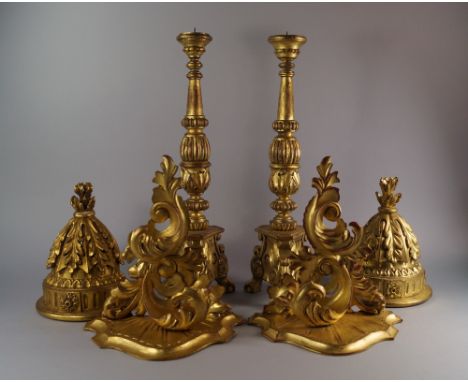 A pair of giltwood pricket sticks, 20th century, in the Spanish taste, with fluted and foliate body, on floral tripod feet, 5