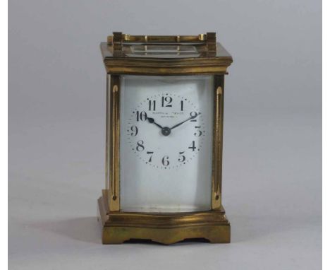 A Mappin and Webb brass carriage time piece, 20th century, with a serpentine front, the white enamel dial with Arabic chapter