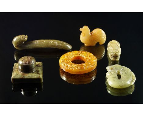 A Chinese jade animalistic form belt hook, possibly 19th century, 10.5cm long, together with a square seal stone, a hardstone