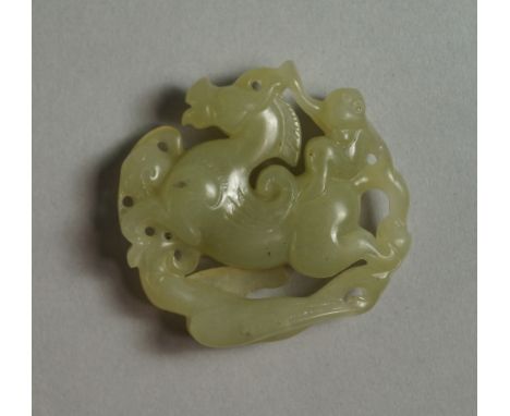 A Chinese jade pendant, late 19th/20th century, pierced in the form of a horse with a monkey riding on its back, 5cm wide
