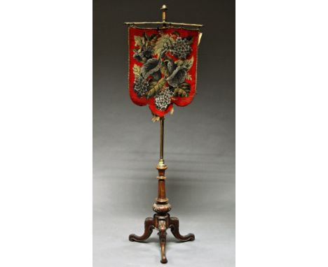 A Victorian brass and walnut pole screen, hung with beaded screen, raised on carved tripod legs, 146 cm high. 
