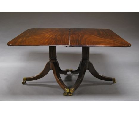 A Victorian mahogany shaped rectangular tripod dining table, raised on fluted stems, 73cm high x 138cm wide.  CONDITION REPOR