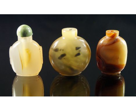 A Chinese carved agate snuff bottle, 19th century, oval handles, raised on cylindrical foot, jade stopper, 6.5 cm high; toget
