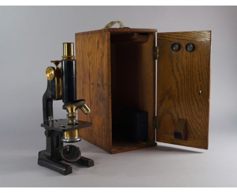 A German microscope, signed to the barrel R. Winkel, Gottingen, together with a small selection of slides by Newton and Co., 