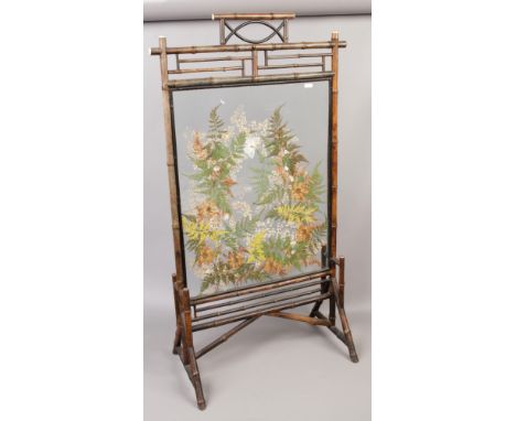 A Victorian Aesthetic Movement bamboo firescreen with pressed flower and butterfly collage panel.