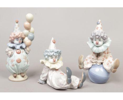 Three Lladro figures of young clowns.
