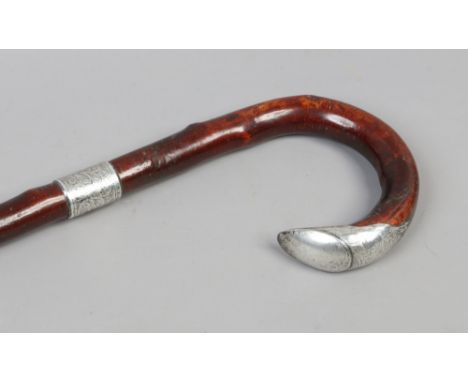 A silver mounted walking stick with curved handled, assayed Chester 1905 by W. H. Carrington &amp; Co.Condition report intend