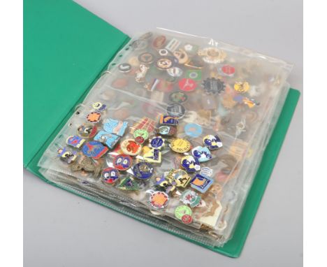 A folder of mostly vintage enamel pin badges including Butlins, advertising, swimming and music examples.