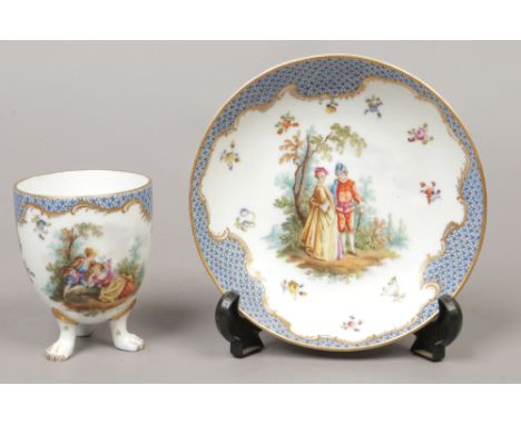 A Helena Wolfsohn Dresden cabinet cup and saucer with scale blue ground and enamelled with Watteaesque scenes, underglaze R m