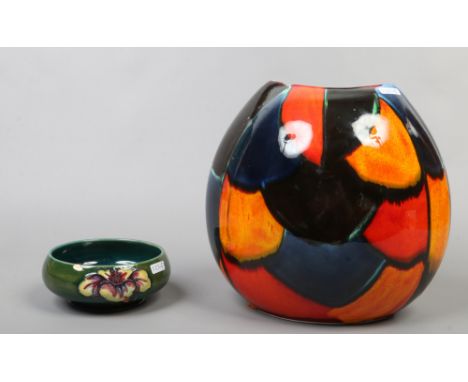 A green ground Moorcroft Hibiscus pattern bowl diameter 17cm along with a large Poole pottery vase.Condition report intended 