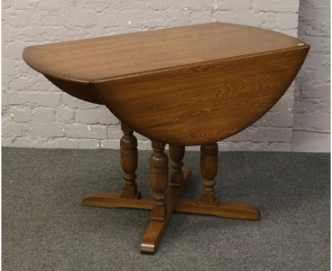 An Ercol Golden Dawn oval drop leaf dining table.