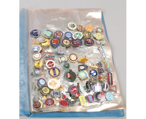 A folder of mostly vintage enamel pin badges including sporting, Rupert the Bear and military examples.