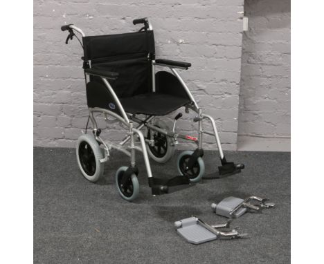 A Days folding wheel chair with spare set of foot rests.