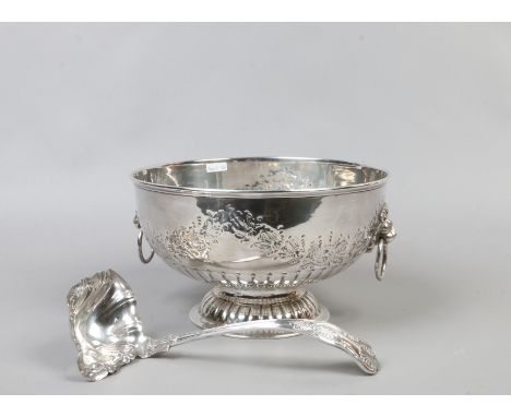 A silver on copper punch bowl with lion head handles along with punch ladle.