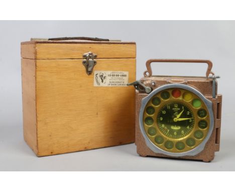 A vintage junior pigeon racing clock in wooden case.