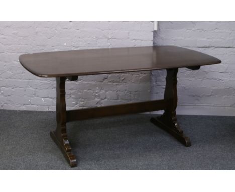 An Ercol refectory table. Height 72cm Width 86cm Length 153cm.