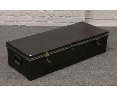 A black painted twin handle tin trunk.